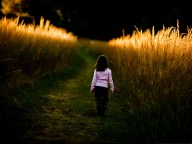 Kid-in-Nature-Little-Girl-Walks-in-Nature-Brown-Wheats-Alongside